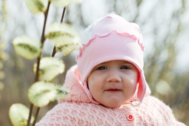 baby wears a pink hat