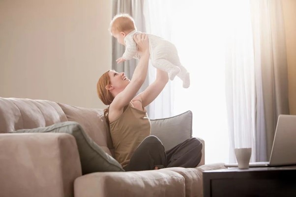 mommy holds her baby up